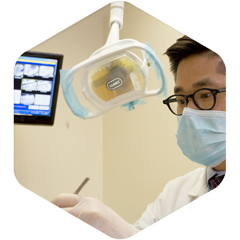 A dentist focused while working on a patient.